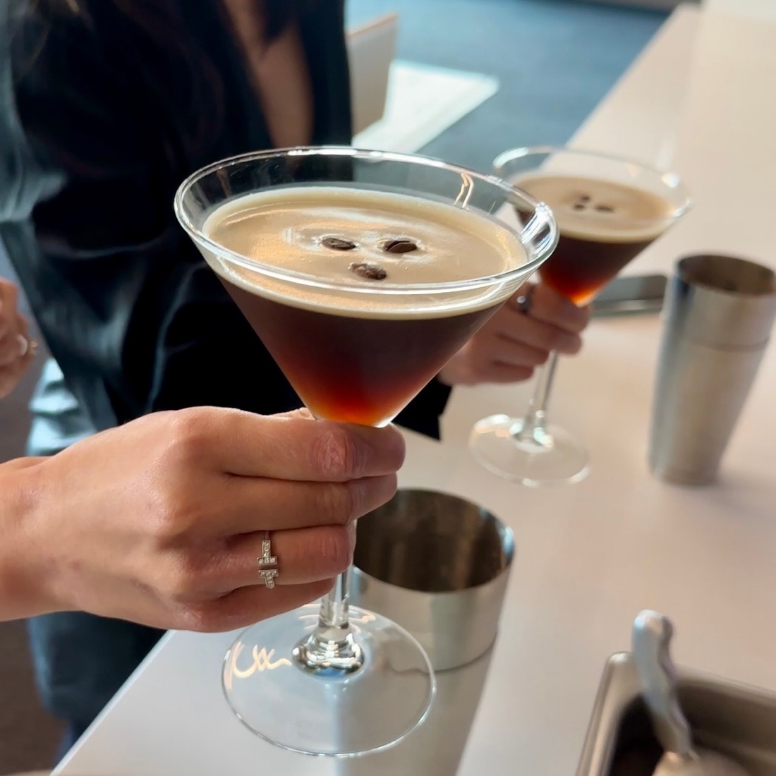 A guest holding an espresso martini they made